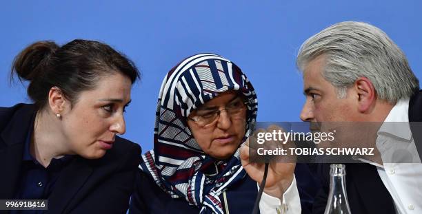 German lawyer Mehmet Daimagueler talks with lawyer Seda Basay and the widow of murdered Enver Simsek, Adile Simsek, during a press conference of the...