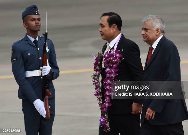 Sri Lankan Prime Minister Ranil Wickremesinghe greets Thailand's Prime Minister Prayut Chan-O-Cha during a welcoming ceremony at the Bandaranaike...