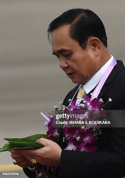 Thailand's Prime Minister Prayut Chan-O-Cha arrives for a welcoming ceremony at Bandaranaike International Airport in Katunayake on July 12, 2018. -...