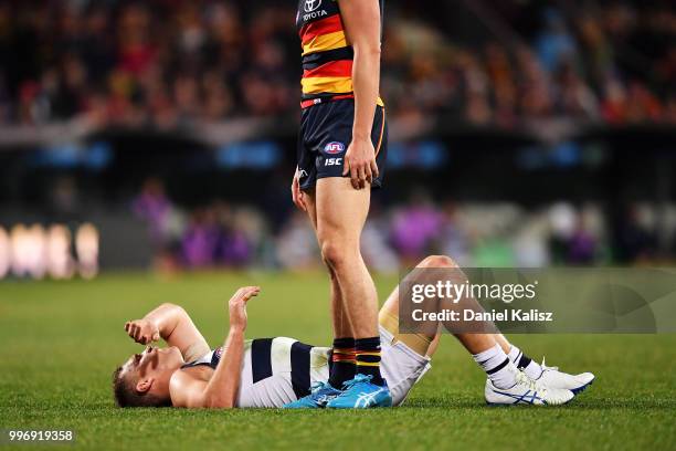 Joel Selwood of the Cats lays on the ground after receiving heavy contact during the round 17 AFL match between the Adelaide Crows and the Geelong...