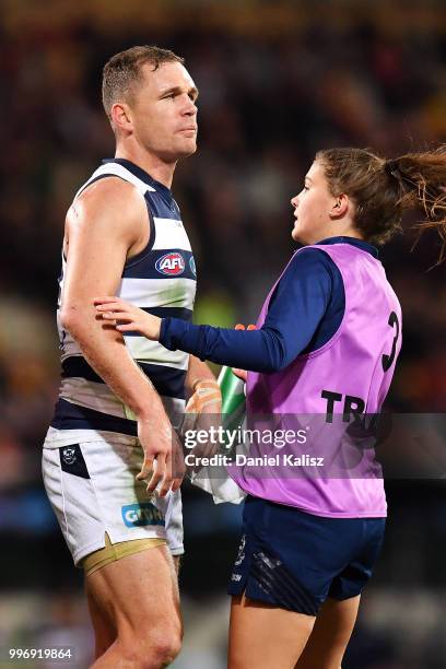 Joel Selwood of the Cats is attended to by trainers during the round 17 AFL match between the Adelaide Crows and the Geelong Cats at Adelaide Oval on...