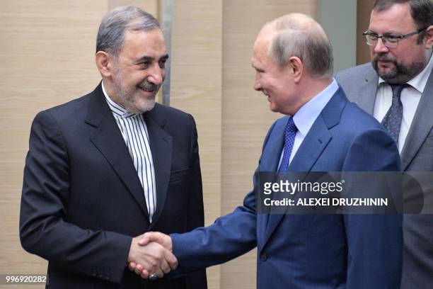 Russian President Vladimir Putin shakes hands with Ali Akbar Velayati, foreign policy advisor to Iran supreme leader, during a meeting at the...