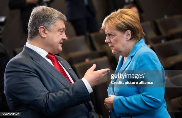 July 2018, Brussels, Belgium: ( Petro Poroshenko, President of Ukraine, and German Chancellor Angela Merkel are talking at the beginning of the...