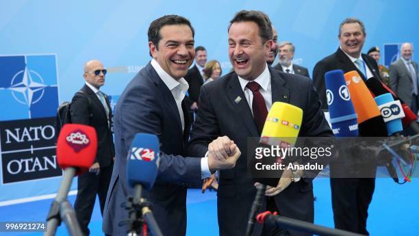 Prime Minister of Greece, Alexis Tsipras and Prime Minister of Luxemburg Xavier Bettel chat upon their arrival on the second day of 2018 NATO Summit...