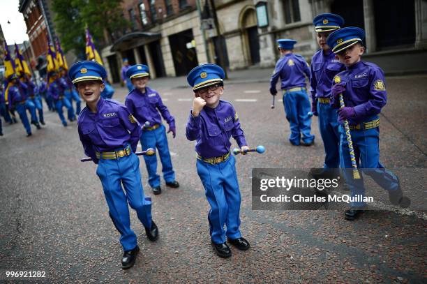 Young band members throw their batons in the air as the annual 12th of July Orange march and demonstration taking place on July 12, 2018 in Belfast,...