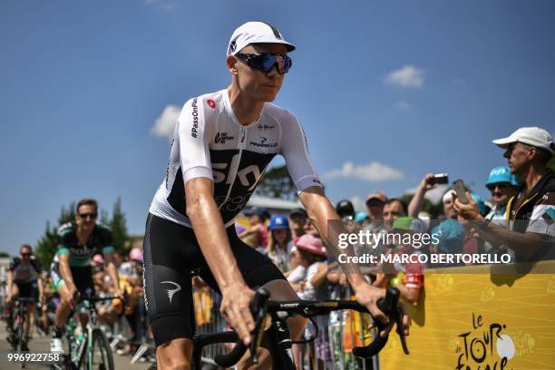 Great Britain's Christopher Froome cycles towards the podium for the signing in ceremony, prior to the sixth stage of the 105th edition of the Tour...