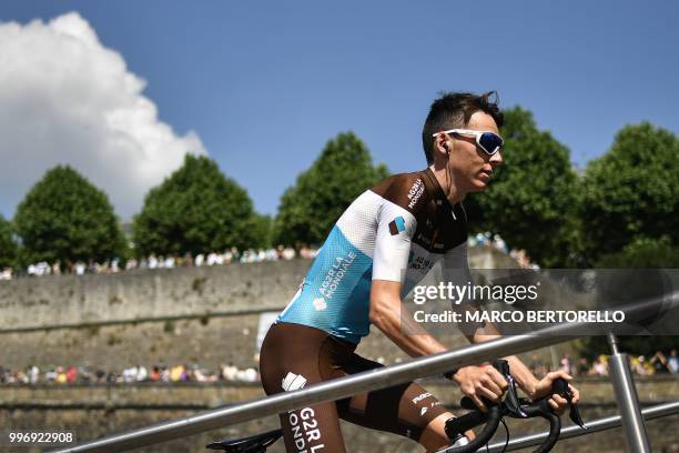 France's Romain Bardet cycles towards the podium for the signing in ceremony, prior to the sixth stage of the 105th edition of the Tour de France...