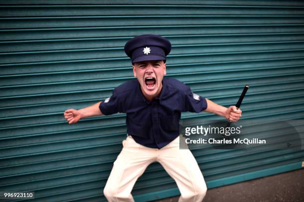 An Orange flute band member screams as the annual 12th of July Orange march and demonstration taking place on July 12, 2018 in Belfast, Northern...