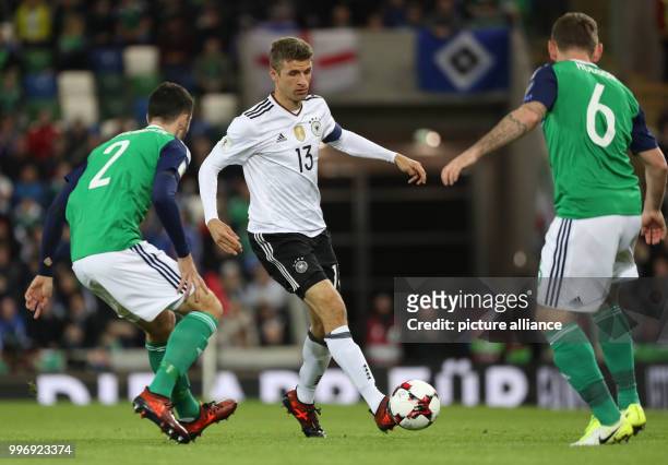 Germany's Thomas Mueller and Northern Ireland's Conor McLaughlin and Lee Hodson in action during the World Cup Group C qualification soccer match...