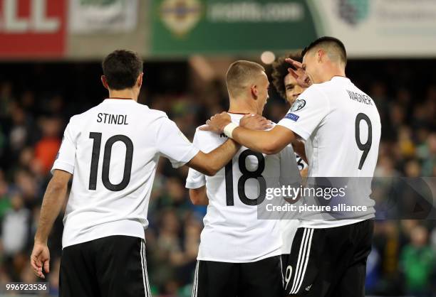 Germany's Joshua Kimmich cheers with team mates Lars Stindl , Leroy Sane and Sandro Wagner over his 0-3 score during the World Cup Group C...