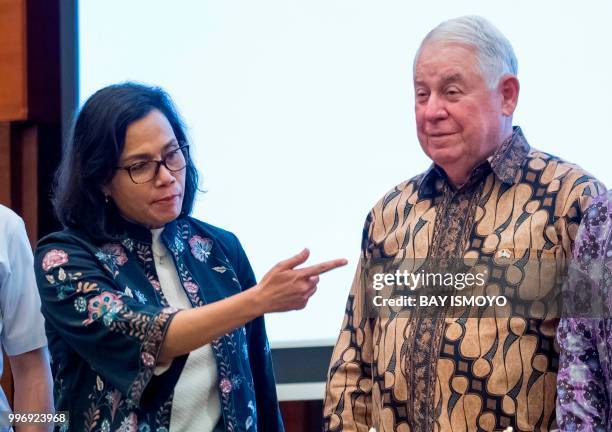 Indonesia's Finance Minister Sri Mulyani gestures next to CEO and vice chairman of Freeport-McMoRan Copper and Gold, Richard Adkerson, before a...