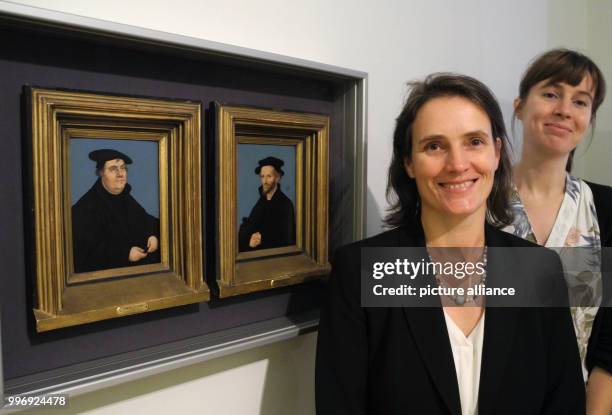 The curator Uta Kuhl and the scientifc assistant Constanze Koester standing beside a portrait of Martin Luther and his wife Katharina von Bora,...