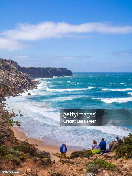 Trekkers enjoying a view of the coastline towards Cape St. Vincent, Portugal's most south westerly point, in the Algarve region. The area is part of...