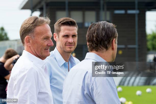 Hans-Joachim Watzke of Dortmund, Sebastian Kehl of Dortmund and Michael Zorc of Dortmund looks on during a training session at BVB trainings center...