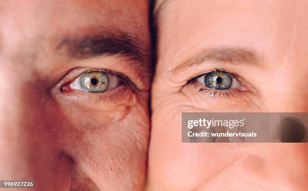 close-up of mature man and woman's faces with green eyes - smiling eyes stock pictures, royalty-free photos & images