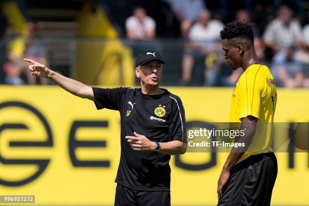 Head coach Lucien Favre of Dortmund speak with Dan-Axel Zagadou of Dortmund during a training session at BVB trainings center on July 9, 2018 in...