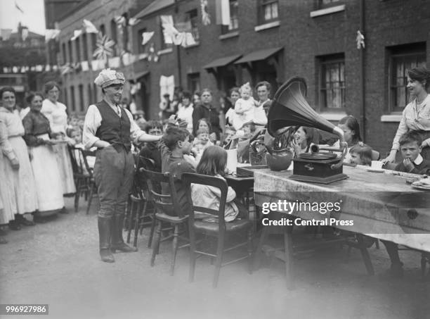 Street party in the East End of London to celebrate the Treaty of Versailles and the end of the First World War, July 1919.