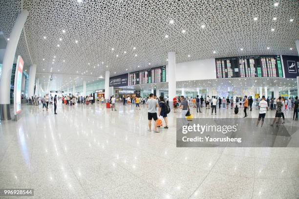 people walking in a busy airport in shenzhen,china. - yaorusheng stock pictures, royalty-free photos & images