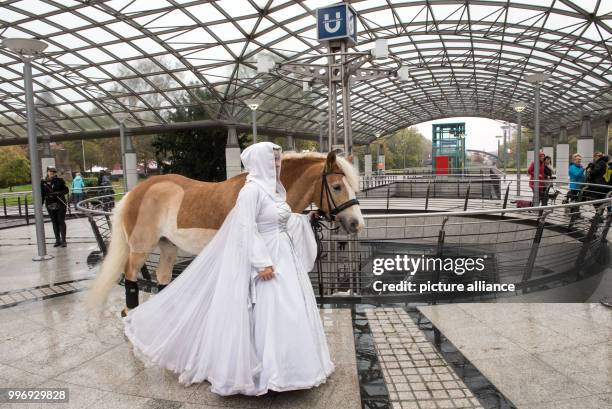 Sandra Olasz from a Spanish riding group passes through an underground station as part of a photo session of the fair "Hund & Pferd" in Dortmund,...