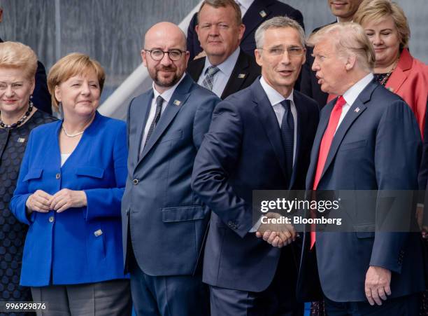 Jens Stoltenberg, secretary general of the North Atlantic Treaty Organization , second right, shakes hands with U.S. President Donald Trump as Angela...