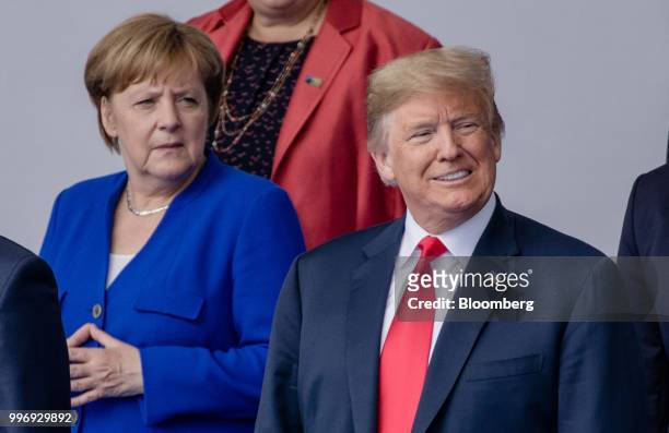 Angela Merkel, Germany's chancellor, left, and U.S. President Donald Trump stand for a family photograph during the North Atlantic Treaty...