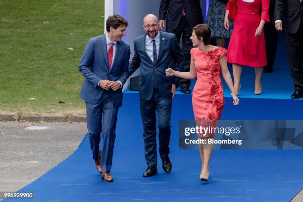 Justin Trudeau, Canada's prime minister, left, walks with Charles Michel, Belgium's prime minister, center, and Amelie Derbaudrenghien, partner of...