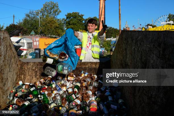 An employee discarding waste glas into a container at the Cannstatt Volksfest in Stuttgart, Germany, 05 October 2017. About four to five tons of...