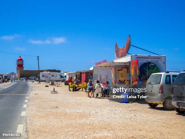 Cars and a German sausage cart near the lighthouse on Cape St. Vincent, Portugal's most south westerly point.
