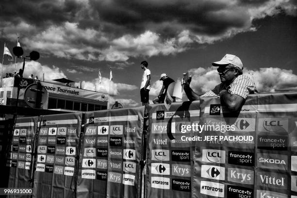 Spectator stands by the finish line during the fifth stage of the 105th edition of the Tour de France cycling race between Lorient and Quimper,...