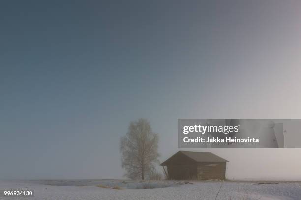 small barn on a misty field - heinovirta stock-fotos und bilder