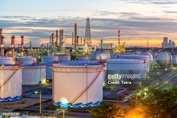 oil and gas industry - refinery at sunset - factory - tetra images stock pictures, royalty-free photos & images