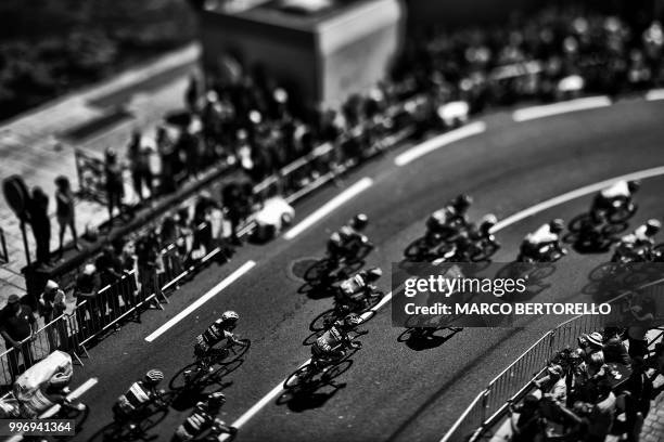 Photo taken with a tilt and shift lens shows the pack riding along the harbour of Concarneau, western France, during the fifth stage of the 105th...