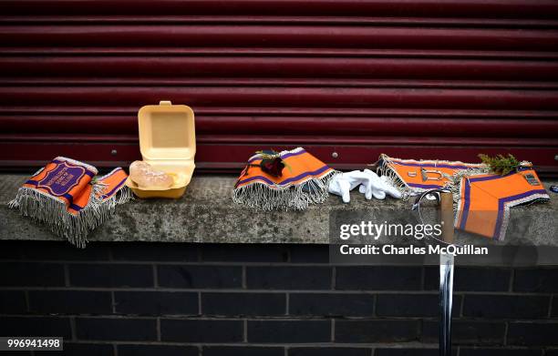 Burger, a sword and several Orange sashes sit on a wall as the annual 12th of July Orange march and demonstration takes place on July 12, 2018 in...