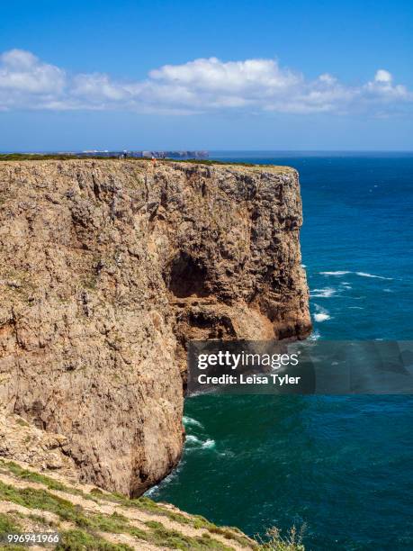Tourists walk on the cliffs at Cape St. Vincent, the south westerly point of Portugal, named after a 3rd century deacon tortured to death by the...