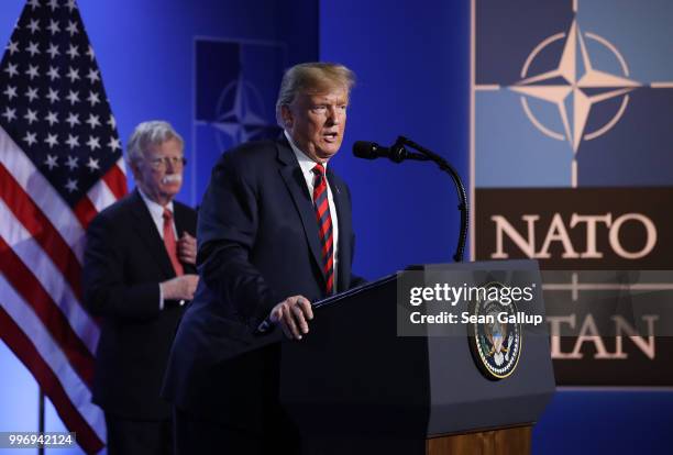 President Donald Trump, flanked by National Security Advisor John Bolton, speaks to the media at a press conference on the second day of the 2018...