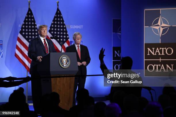 President Donald Trump, flanked by National Security Advisor John Bolton, speaks to the media at a press conference on the second day of the 2018...