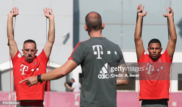 Franck Ribery and Serge Gnabry of FC Bayern Muenchen practice during a training session at the club's Saebener Strasse training ground on July 12,...