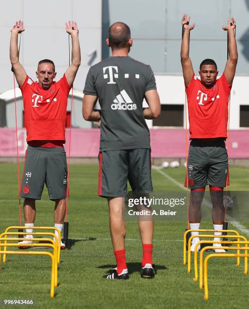 Franck Ribery and Serge Gnabry of FC Bayern Muenchen practice during a training session at the club's Saebener Strasse training ground on July 12,...