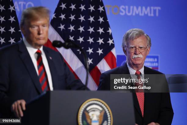 President Donald Trump, flanked by National Security Advisor John Bolton, speaks to the media at a press conference on the second day of the 2018...