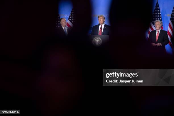 President Donald Trump speaks in between U.S. Secretary of State Mike Pompeo and National Security Advisor John Bolton during a news conference at...