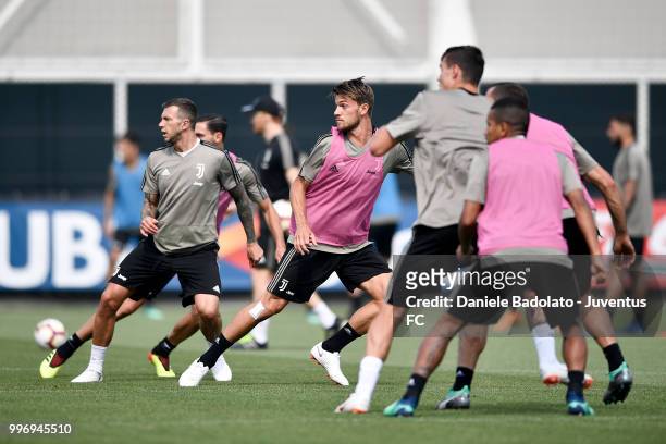 Federico Bernardeschi and Daniele Rugani during a Juventus training session at Juventus Training Center on July 12, 2018 in Turin, Italy.
