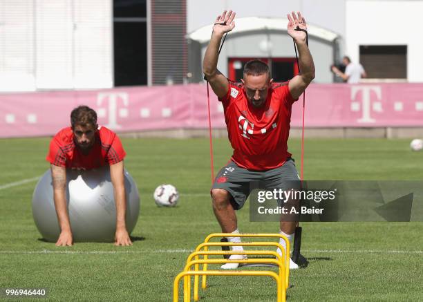 Javi Martinez and Franck Ribery of FC Bayern Muenchen practice during a training session at the club's Saebener Strasse training ground on July 12,...