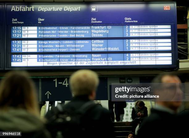 'Wegen Unwetter ist der Zugverkehr komplett eingestellt' can be seen on a display board at the Bahnhof Zoo station in Berlin, Germany, 5 October...