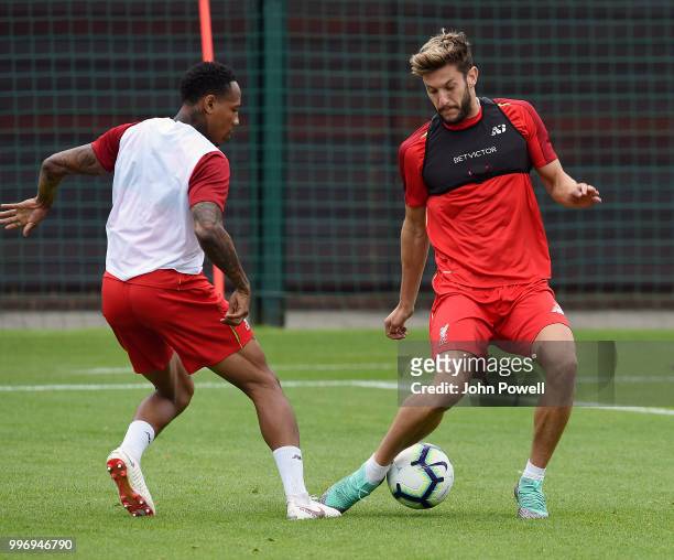 Adam Lallana and Nathaniel Clyne of Liverpool during a training session at Melwood Training Ground on July 12, 2018 in Liverpool, England.