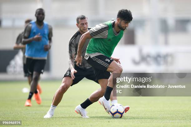 Federico Bernardeschi and Emre Can during a Juventus training session at Juventus Training Center on July 12, 2018 in Turin, Italy.