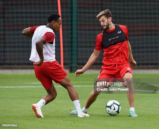 Adam Lallana and Nathaniel Clyne of Liverpool during a training session at Melwood Training Ground on July 12, 2018 in Liverpool, England.