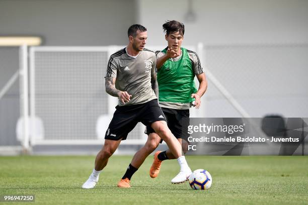 Federico Bernardeschi and Pietro Beruatto during a Juventus training session at Juventus Training Center on July 12, 2018 in Turin, Italy.