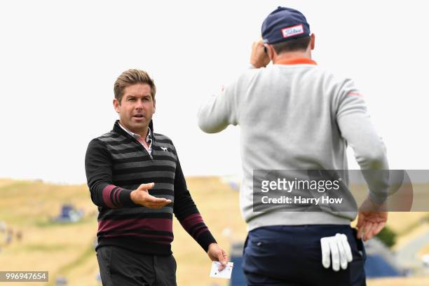 Robert Rock of England shakes hands with Julien Guerrier of France on hole eighteen during day one of the Aberdeen Standard Investments Scottish Open...