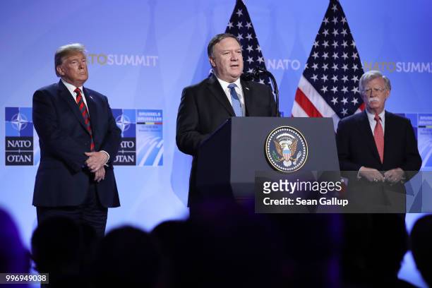 President Donald Trump and National Security Advisor John Bolton look on as U.S. Secretary of State Mike Pompeo speaks briefly to the media at a...