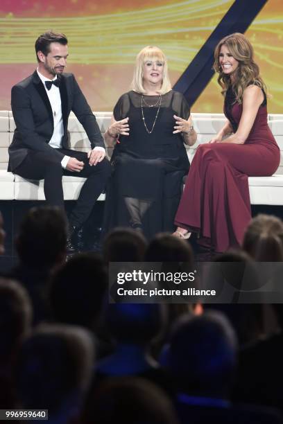 The singer Florian Silbereisen , the chairwoman of the "Tribute to Bambi" foundation Patricia Riekel and moderator Mareile Hoeppner speak on stage,...